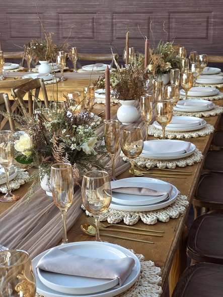 Rustic wooden table set with amber champagne flutes, macramé placemats and dried botanical centrepieces at Muano